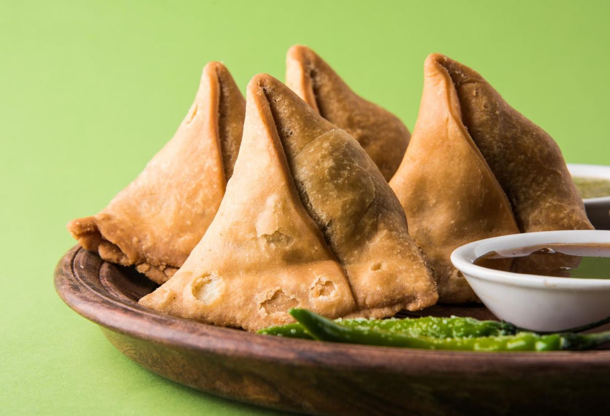 Tasty Samosas with ketchup in plate